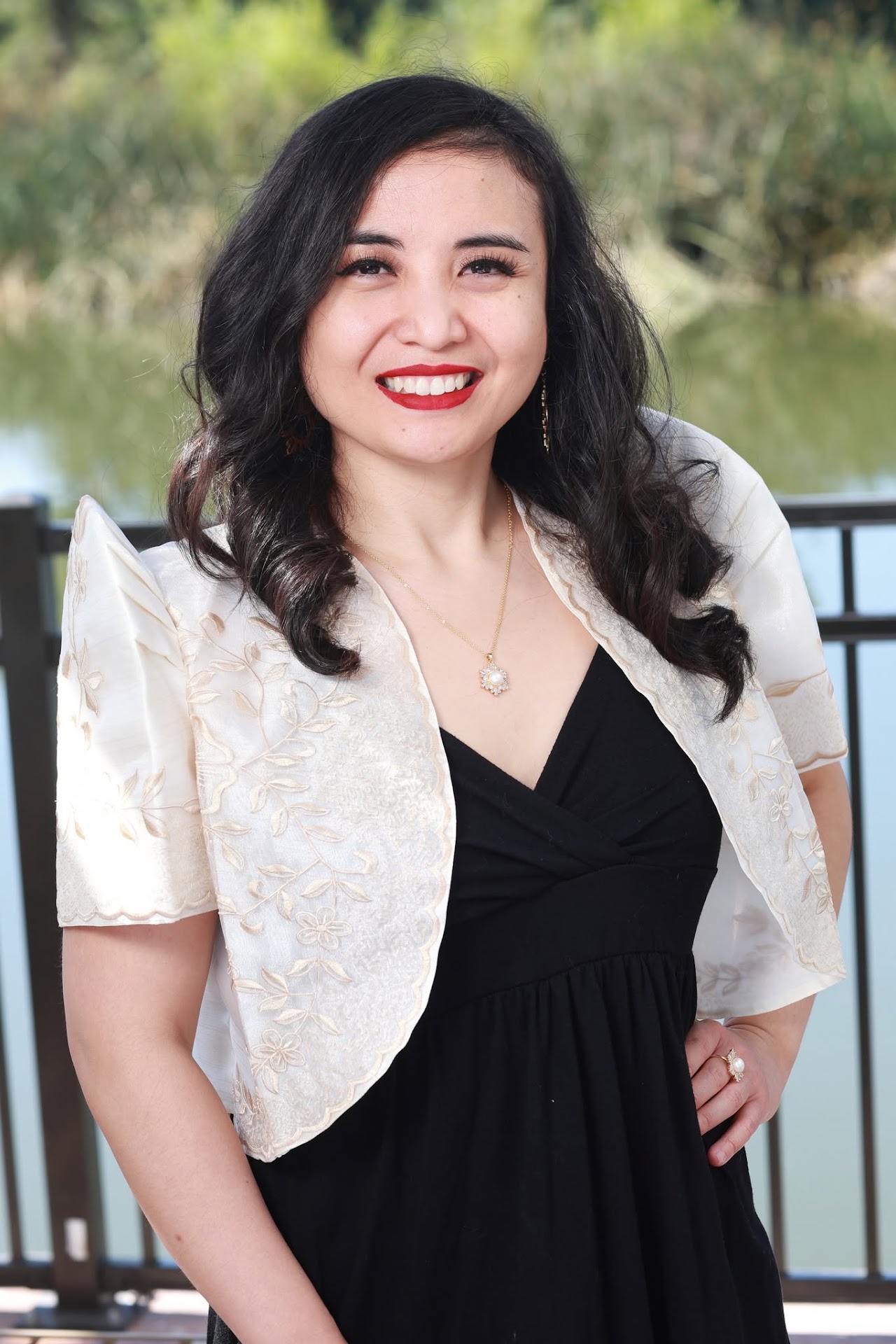 Dr. Edith Montemayor wearing a black dress and cream embroidered Filipino jacket.