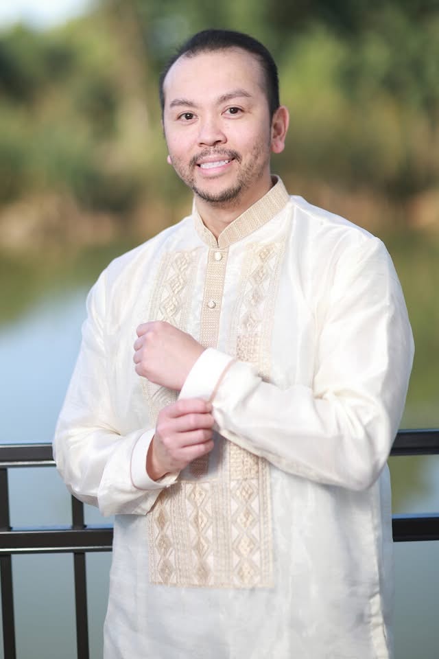 John Tran wearing a cream barong Tagalog.
