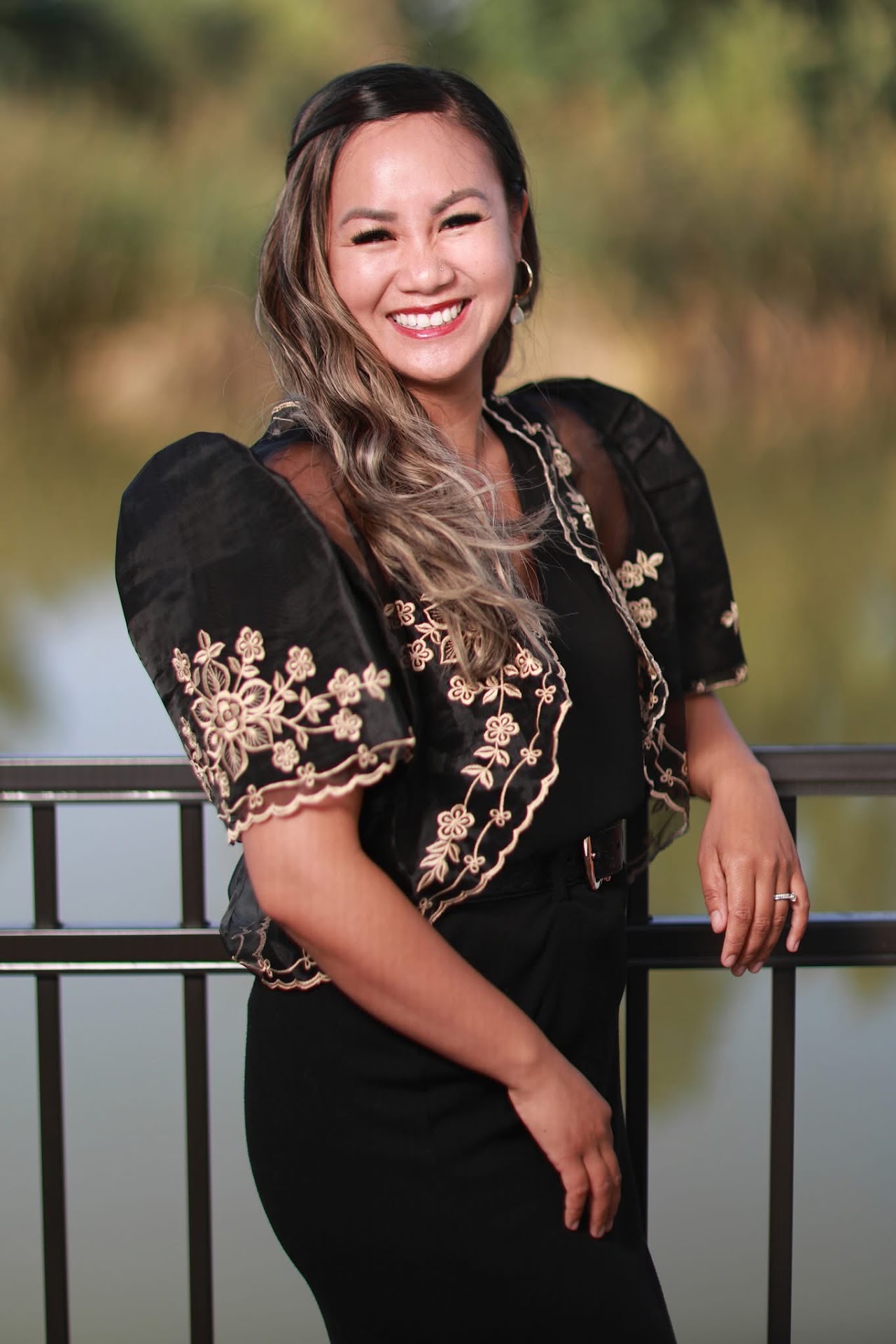Rochelle Datangel wearing a black blouse with gold floral embroidery.